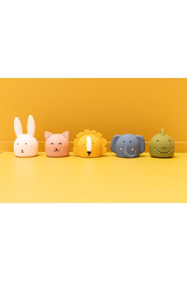 2. Collection of Trixie Baby silicone night lights in animal shapes on yellow background