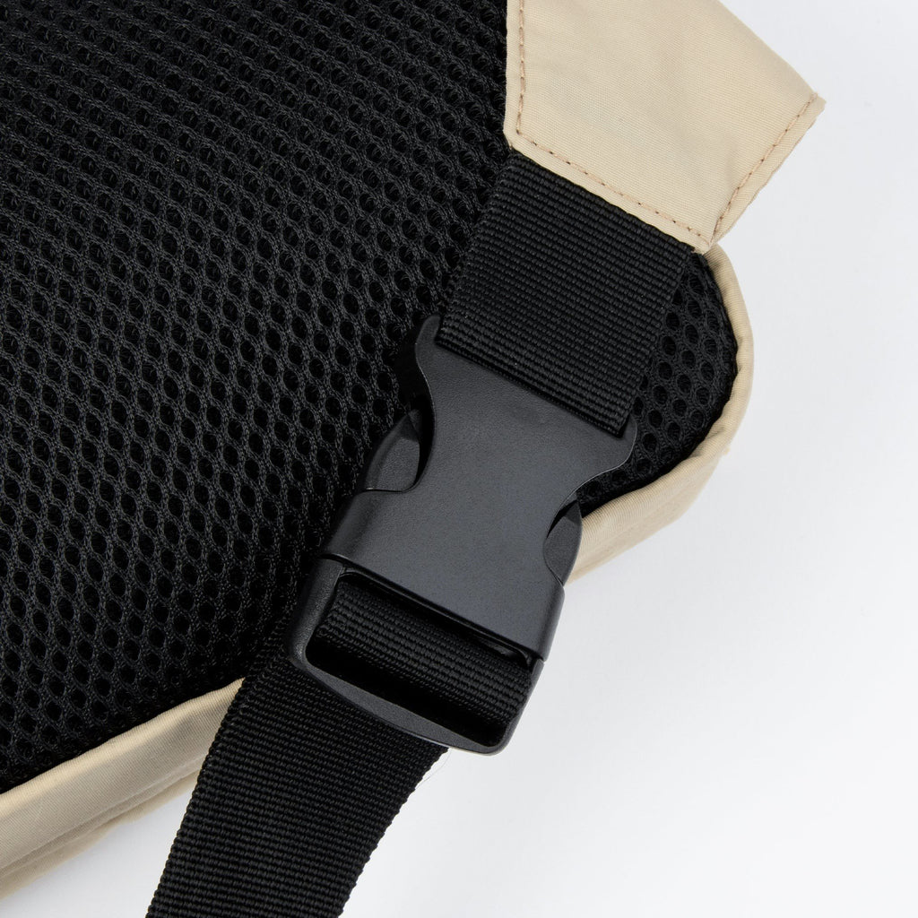 3. Close-up of black buckle and strap on beige Sniff Retro Waist Bag