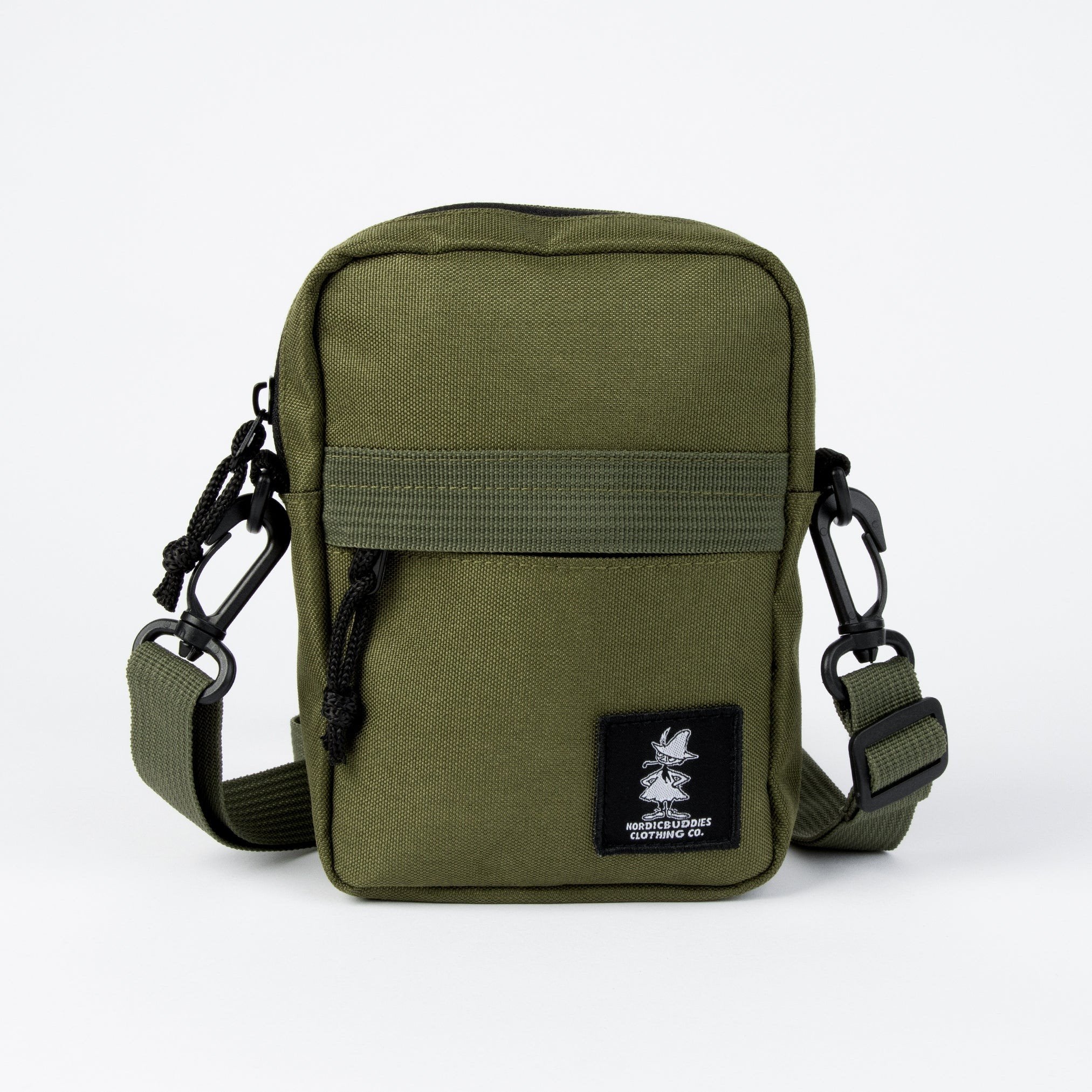 2. Green Snufkin travel cross body bag by Moomin NordicBuddies with black logo patch on front, shown in studio setting