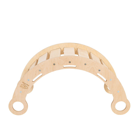 3. Side view of Snug Rocker for kids in natural birch plywood, showing slatted construction and rounded handles