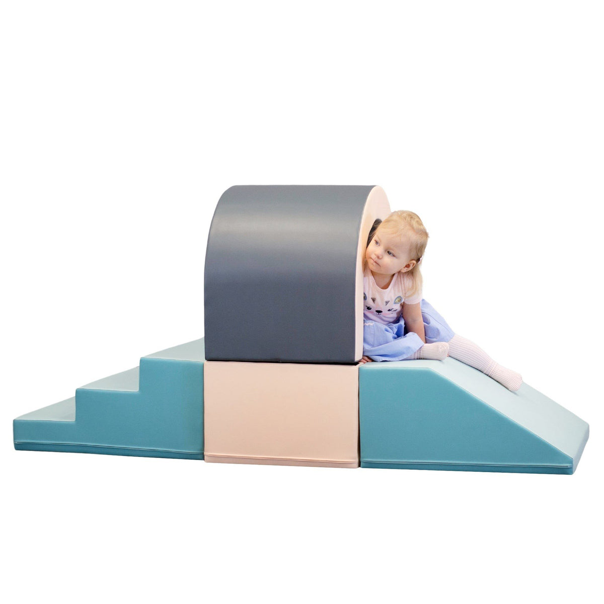 1. Girl peeking through IGLU pastel soft play tunnel set in studio setting