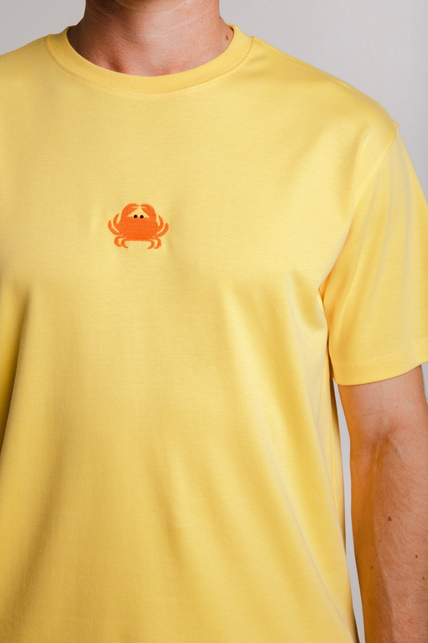 5. Detailed view of Sossu's yellow Crab Heavy T-shirt fabric and logo