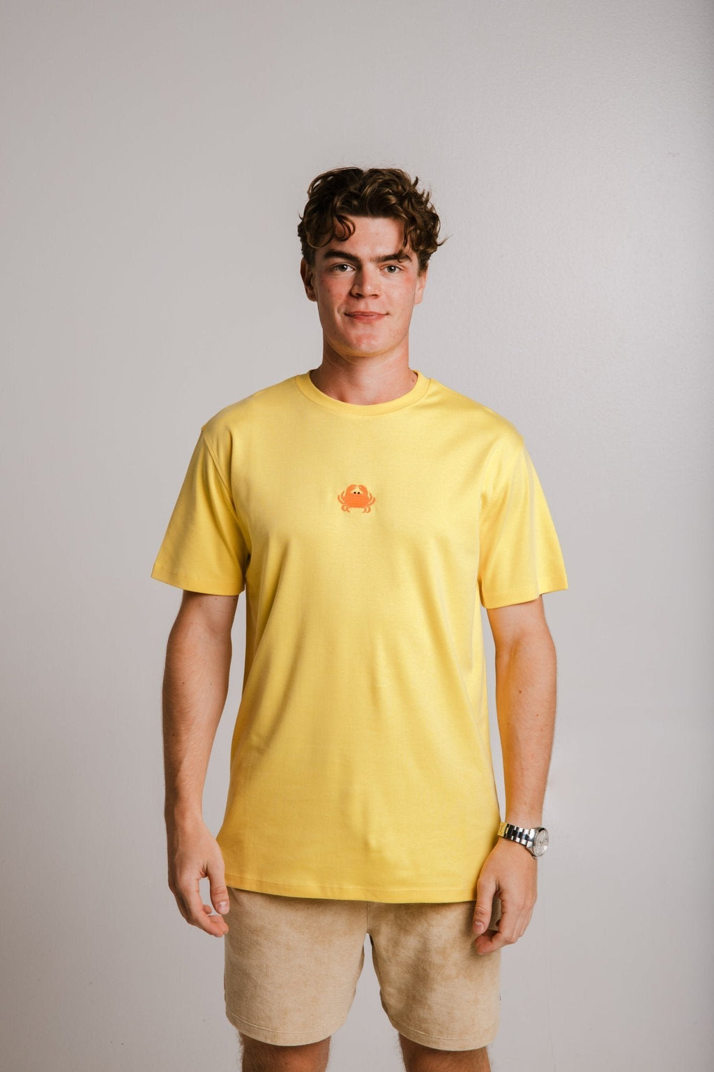 1. Unisex yellow Crab Heavy T-shirt by Sossu worn by male model in studio setting