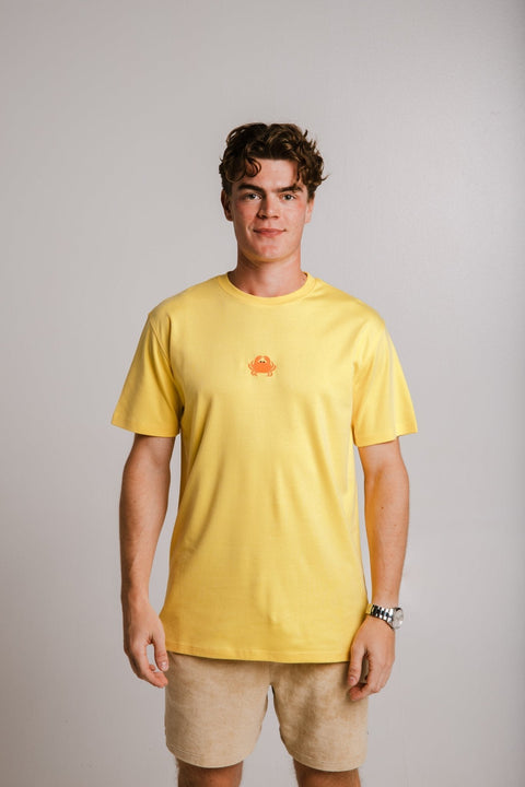 1. Unisex yellow Crab Heavy T-shirt by Sossu worn by male model in studio setting