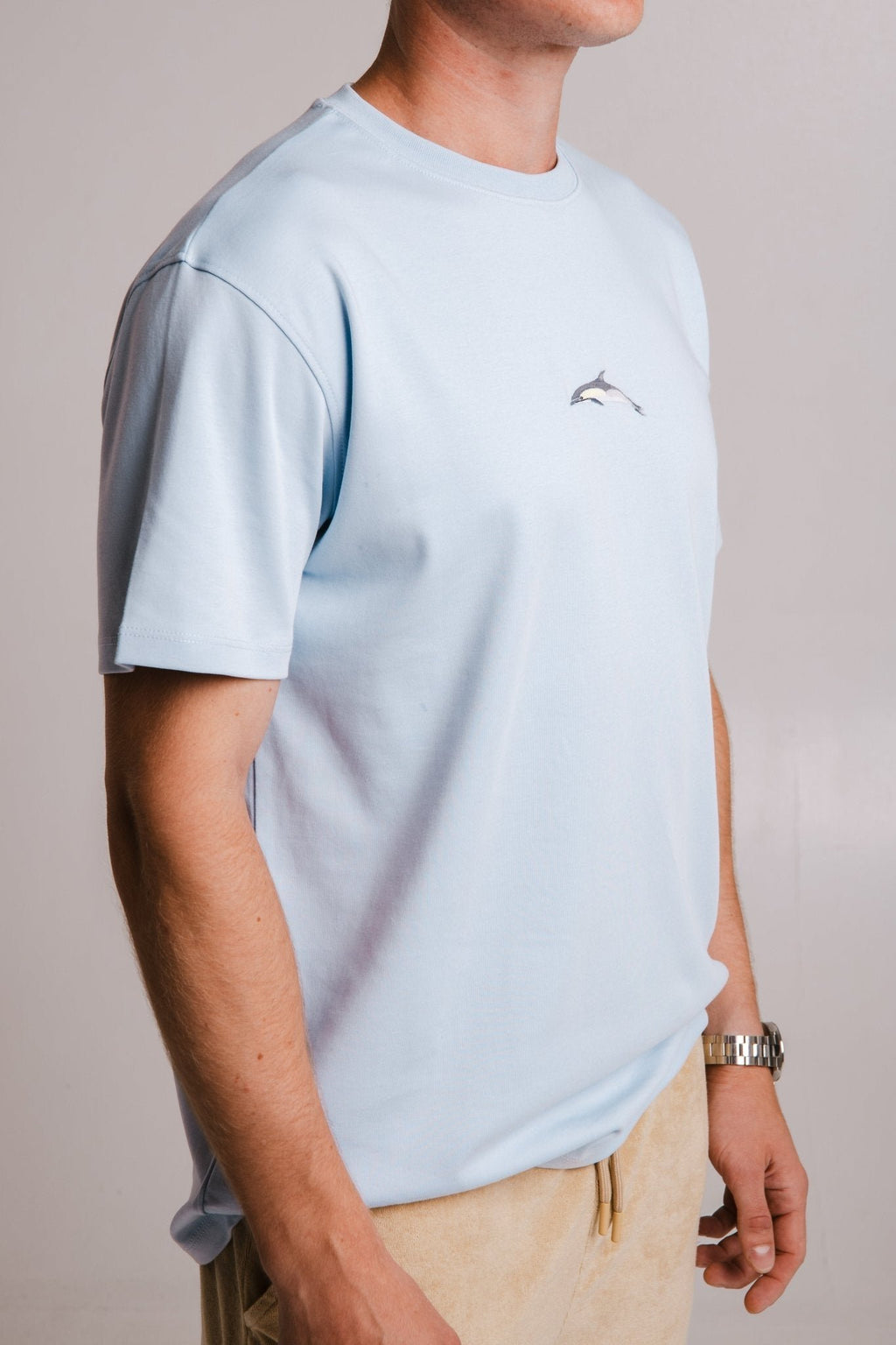 2. Side view of men's light blue Dolphin Heavy T-shirt by Sossu, highlighting embroidered dolphin design