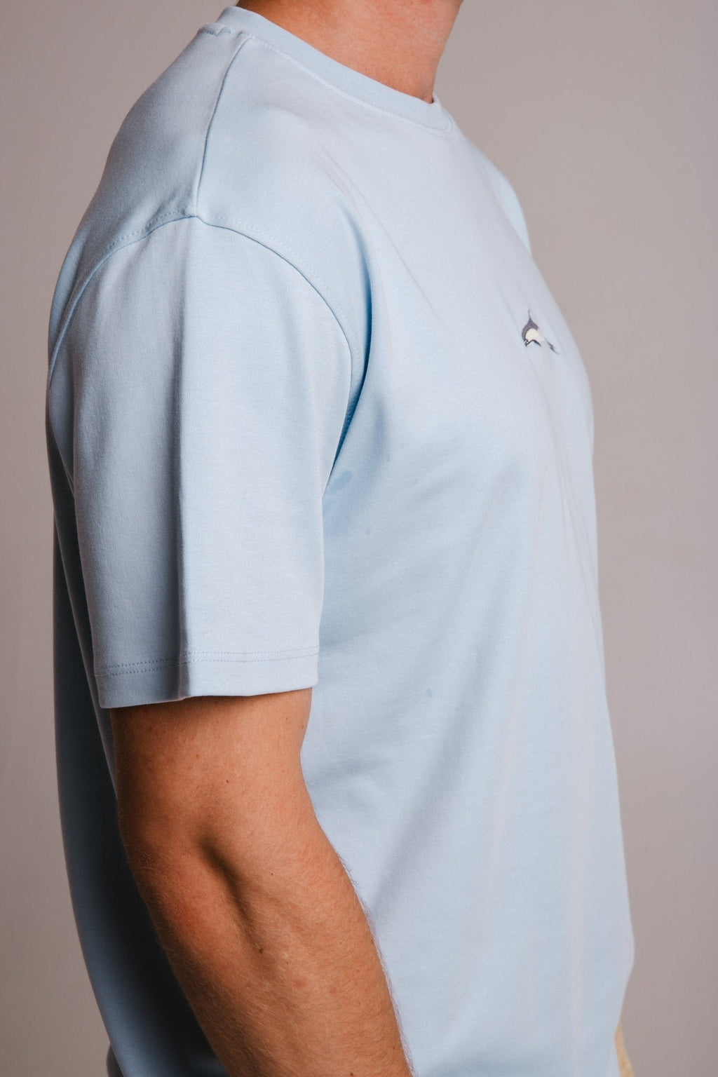 3. Close-up of men's light blue Dolphin Heavy T-shirt by Sossu, showcasing sleeve and fabric texture