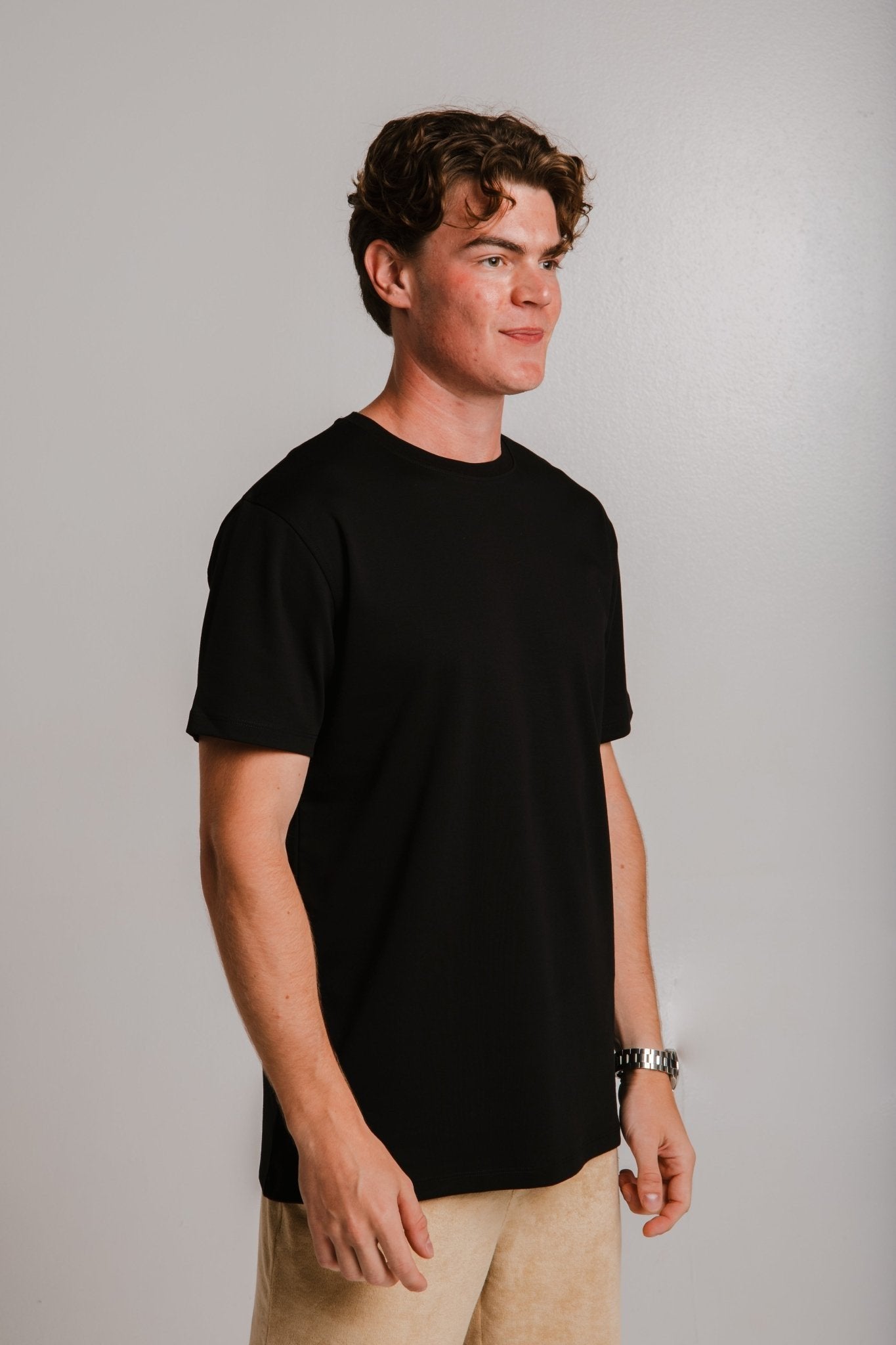 2. Male model wearing Sossu black heavy t-shirt, shown in studio