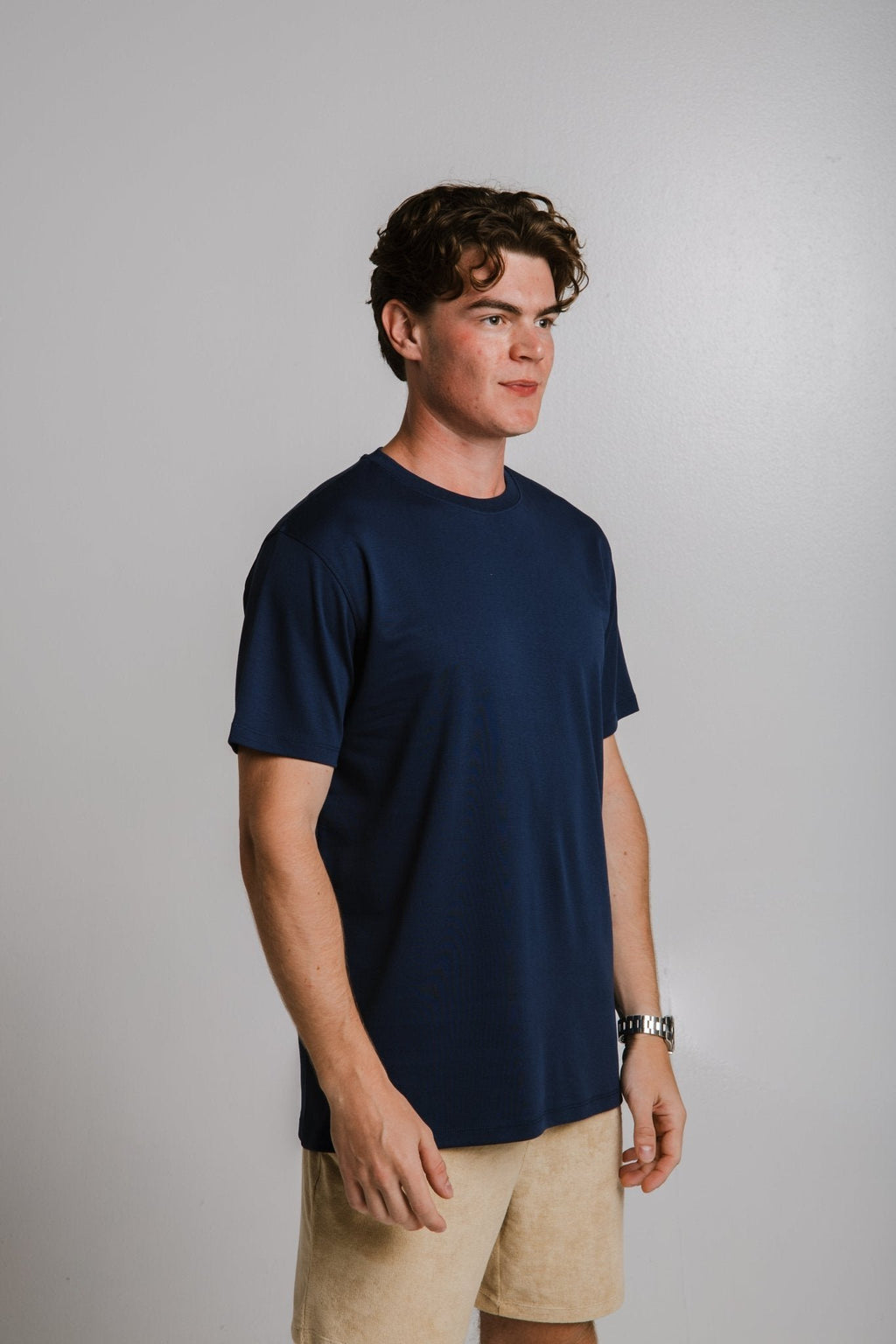 2. Unisex navy blue heavy T-shirt by Sossu worn by male model in studio, side view