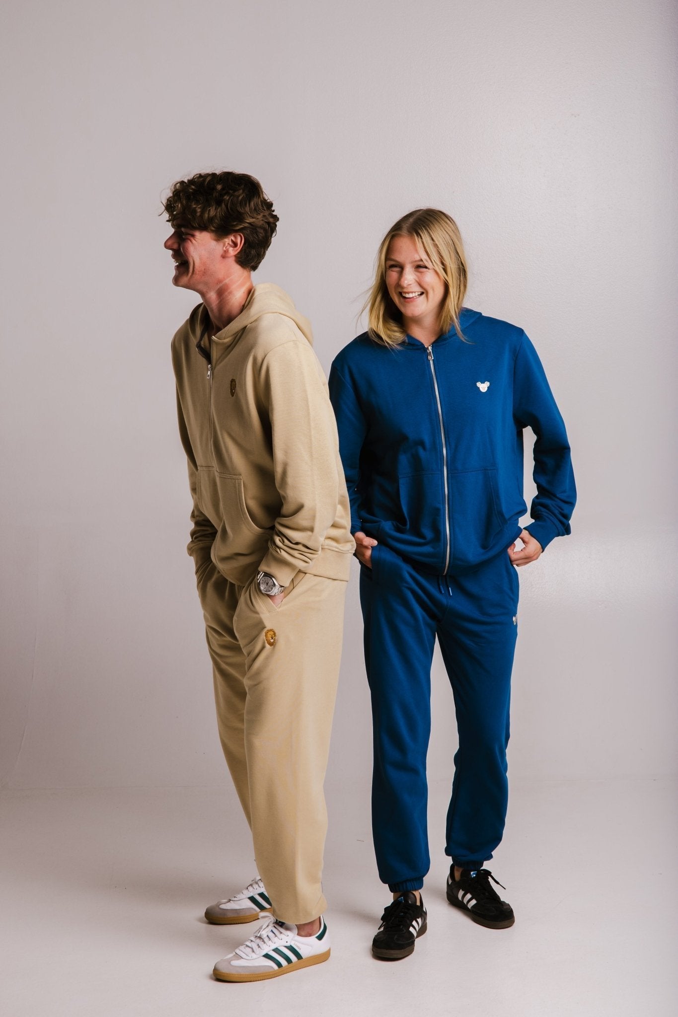 4. Unisex Lion Soft Fleece Full Zip Hoodie in light brown and blue, worn by male and female models laughing, studio setting