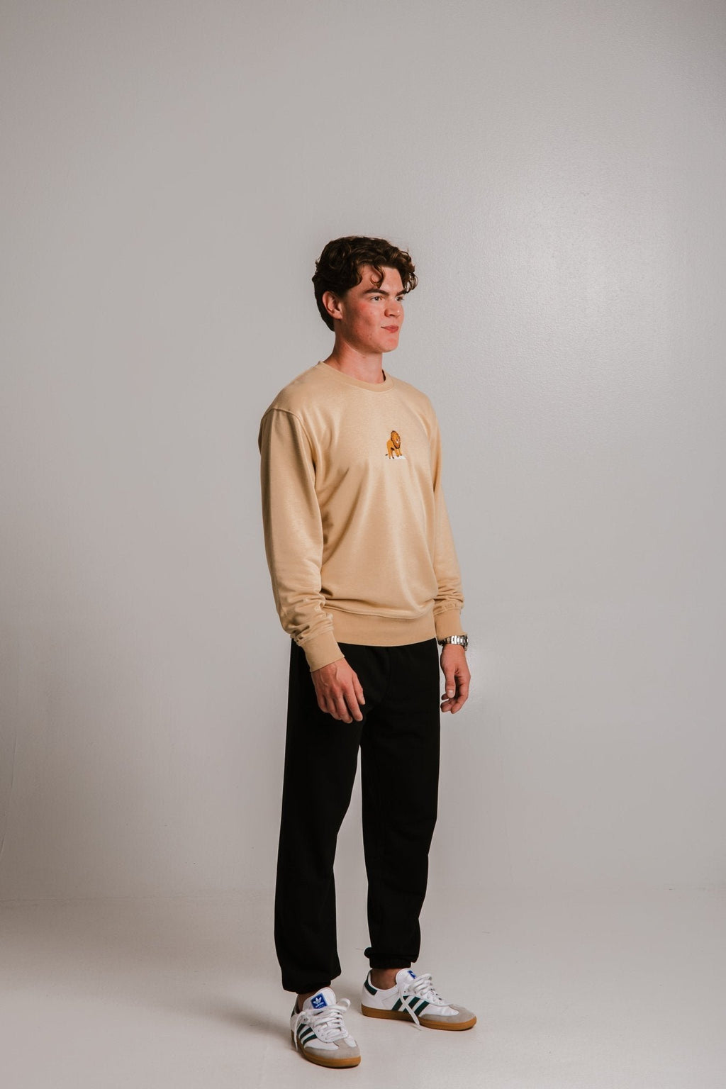 3. Unisex light brown Lion Soft Fleece Sweatshirt by Sossu worn by male model, full body view in studio
