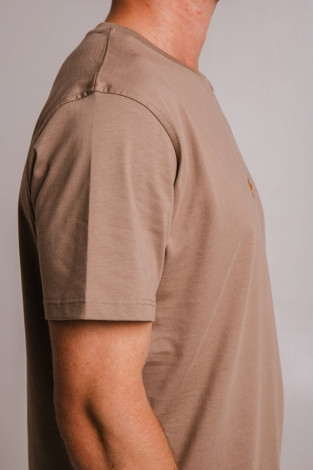 4. Side profile of Sossu Lion T-shirt in Milky Brown, emphasizing lightweight cotton fabric and fit