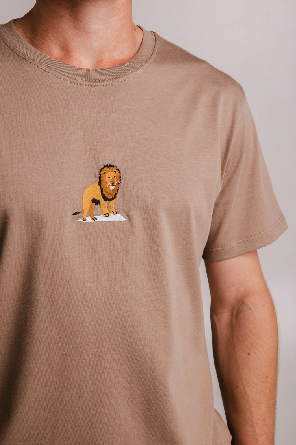 2. Close-up of Sossu Lion T-shirt in Milky Brown, highlighting embroidered lion design on chest