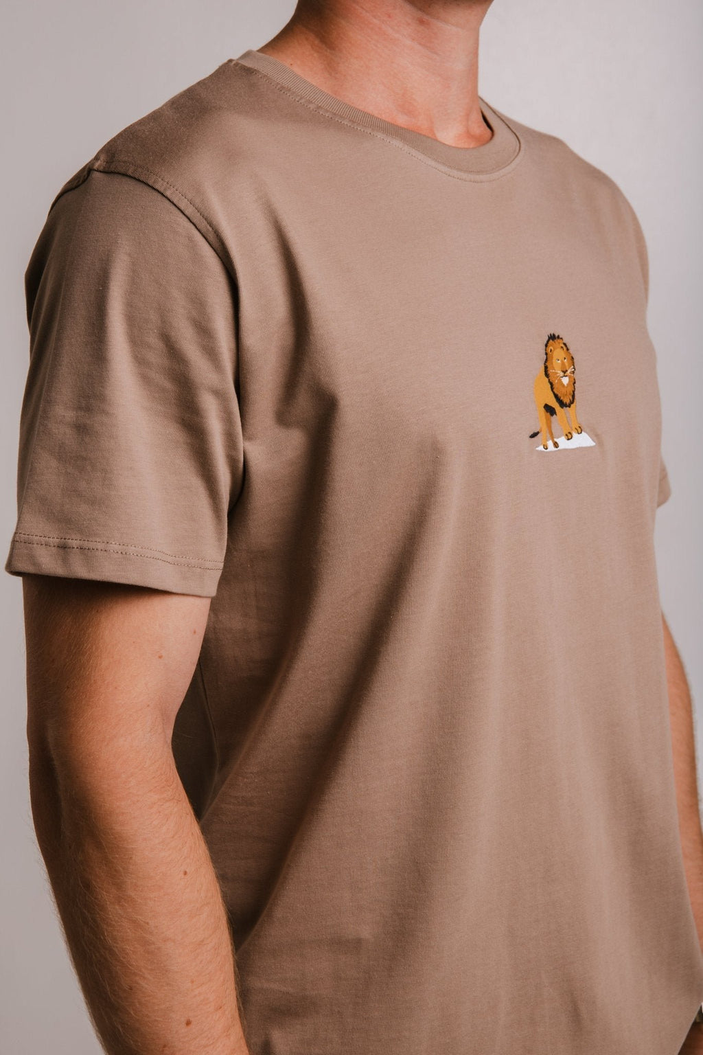 3. Side view of Sossu Lion T-shirt in Milky Brown, showing embroidered lion detail and regular fit