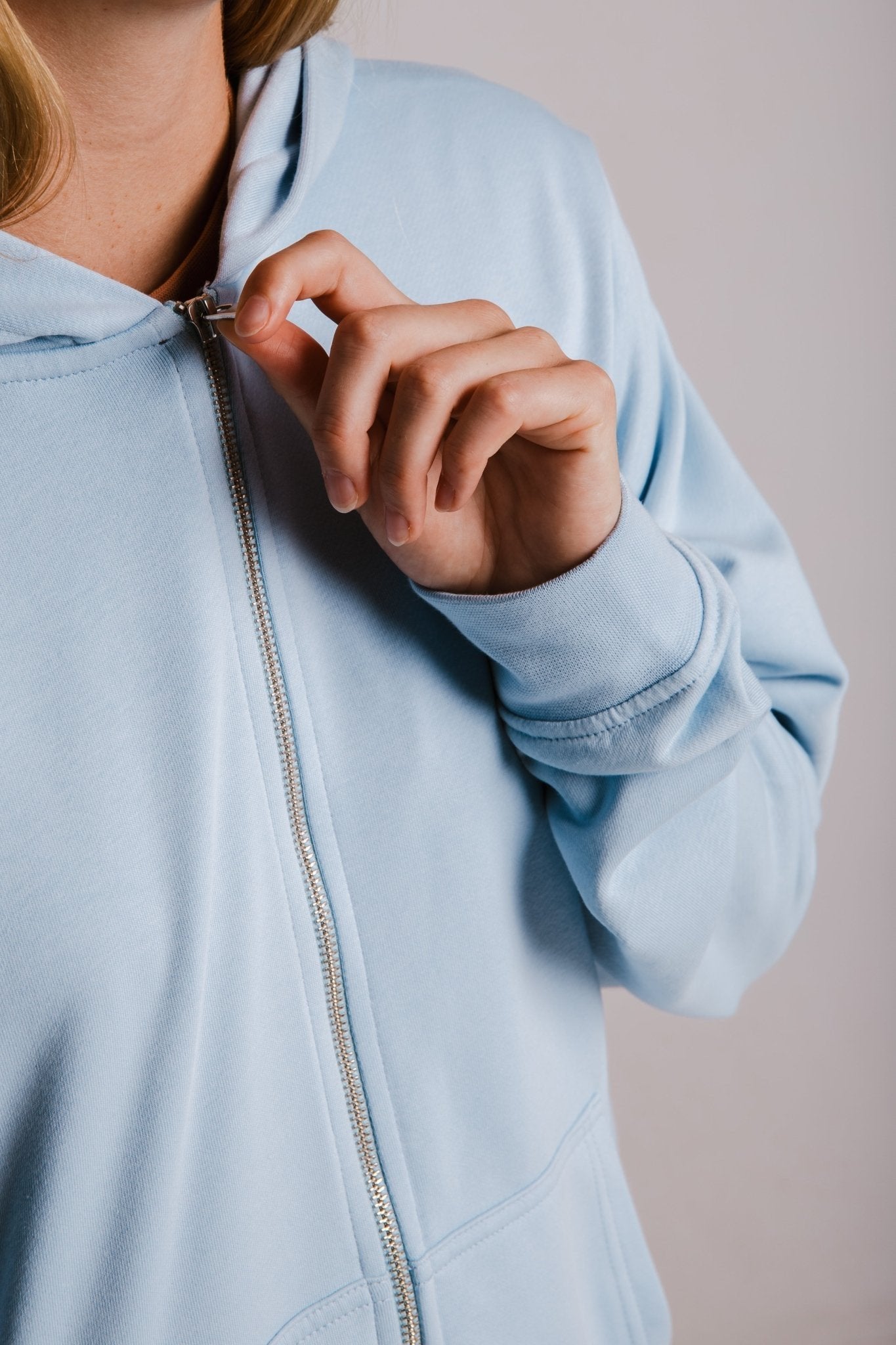 4. Close-up of Sossu light blue Panda Soft Fleece Full Zip Hoodie zipper detail, studio shot