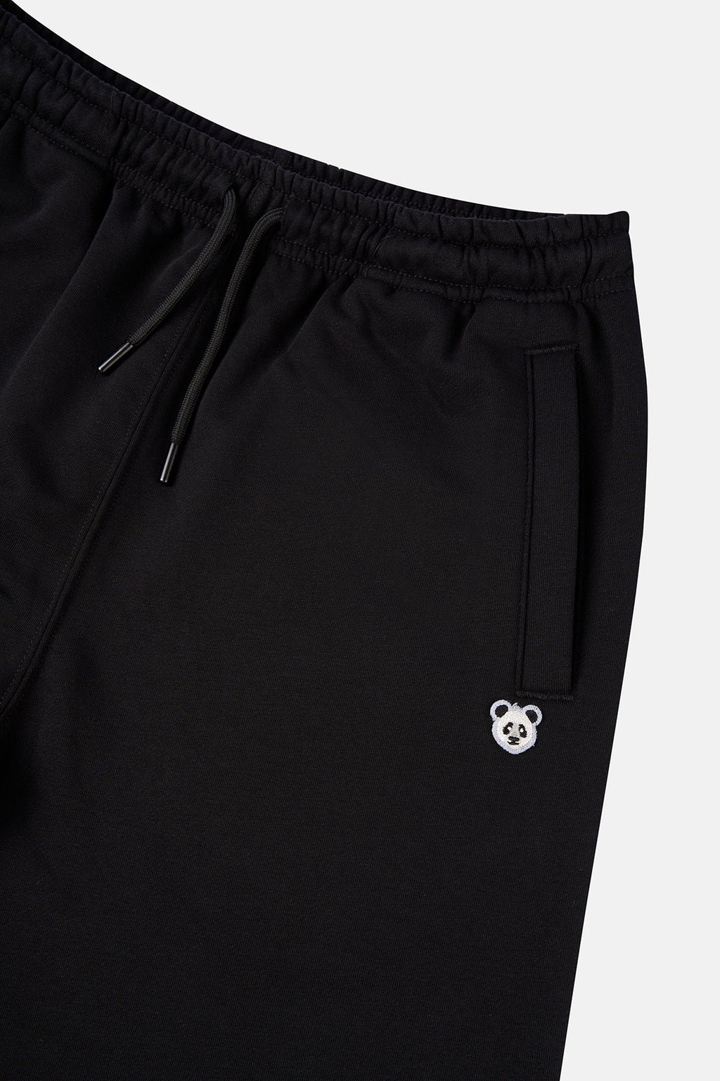 7. Flat lay of unisex black Panda Soft Fleece Sweatpants by Sossu showing front design