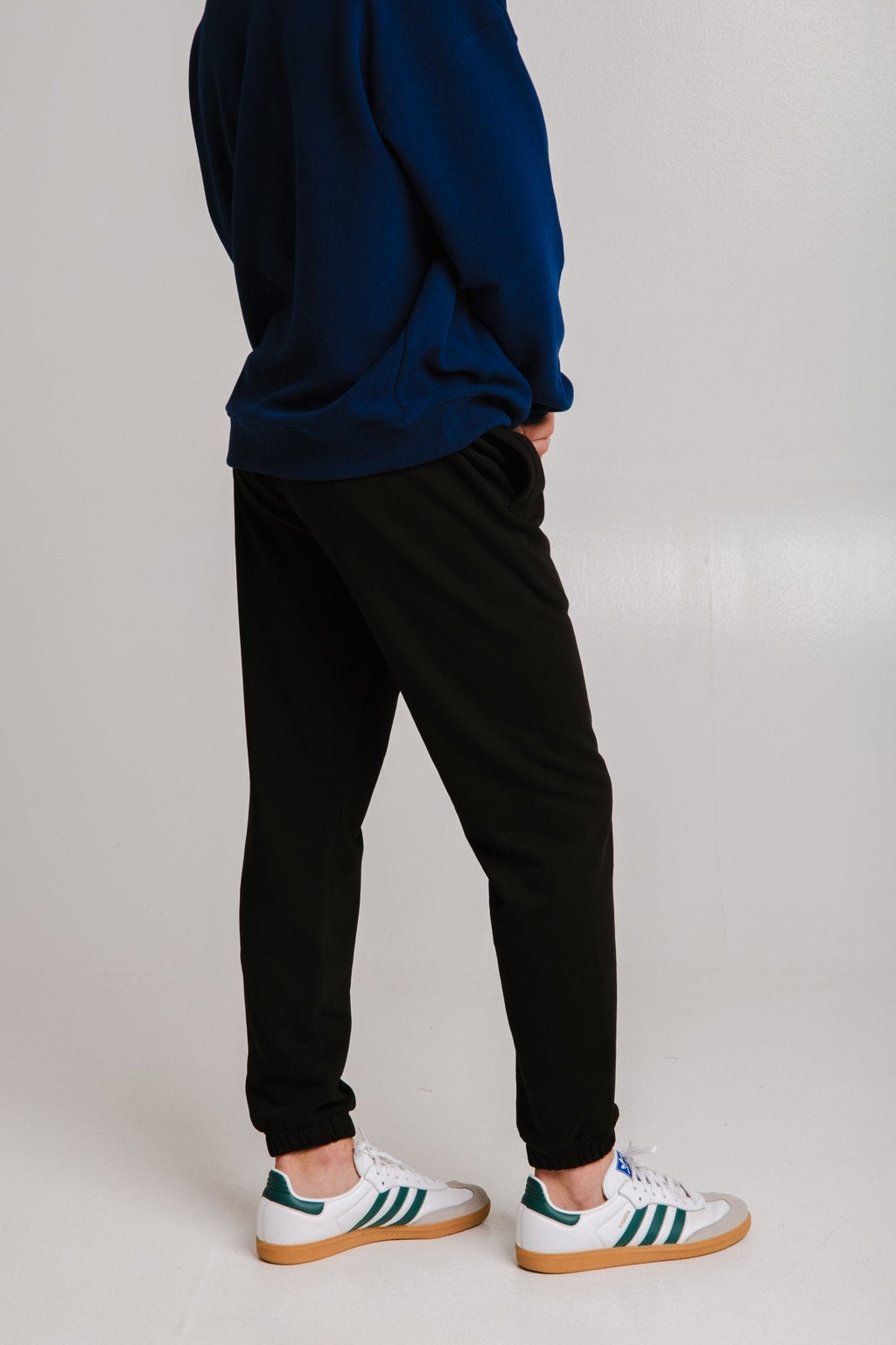 2. Unisex black Panda Soft Fleece Sweatpants by Sossu shown from the back in studio