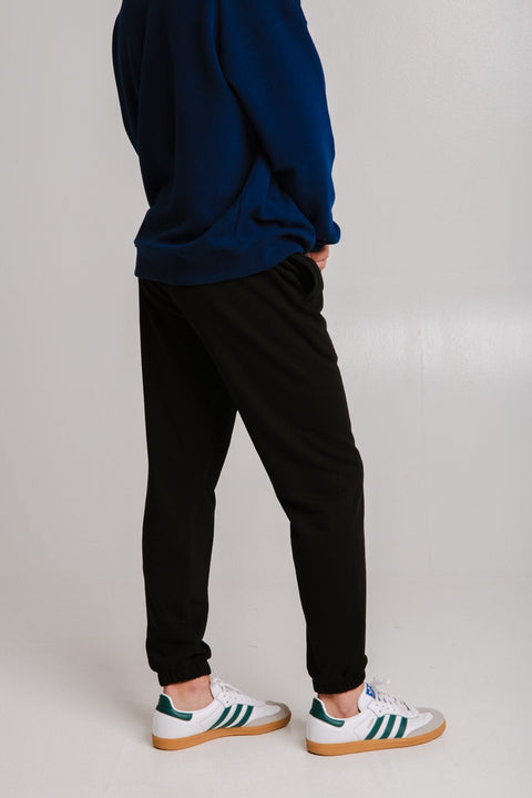 2. Unisex black Panda Soft Fleece Sweatpants by Sossu shown from the back in studio