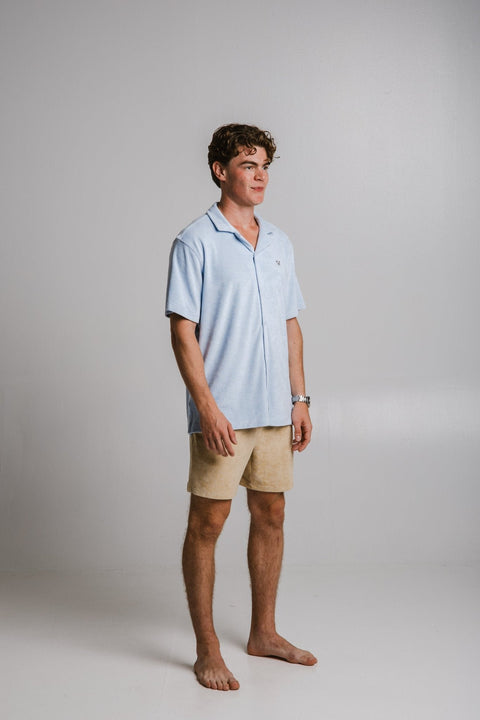 2. Side view of men's light blue Panda Terry Shirt by Sossu, styled with beige shorts