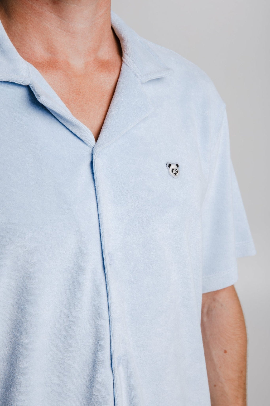 5. Close-up of embroidered panda detail on light blue Panda Terry Shirt by Sossu