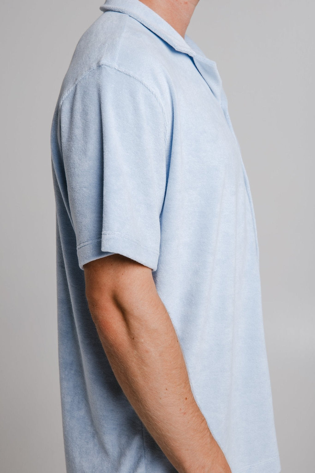 6. Side detail of men's light blue Panda Terry Shirt by Sossu, showing sleeve and fabric