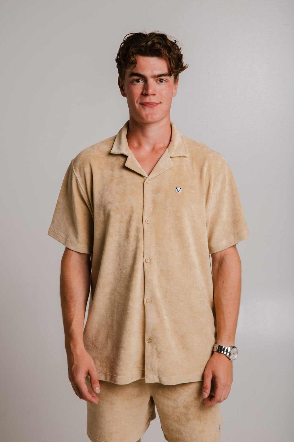 4. Front view of unisex light brown Panda Terry Shirt by Sossu worn by male model, studio setting