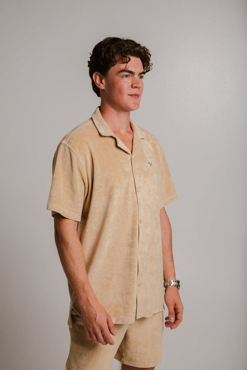 3. Side view of unisex light brown Panda Terry Shirt by Sossu worn by male model, studio setting