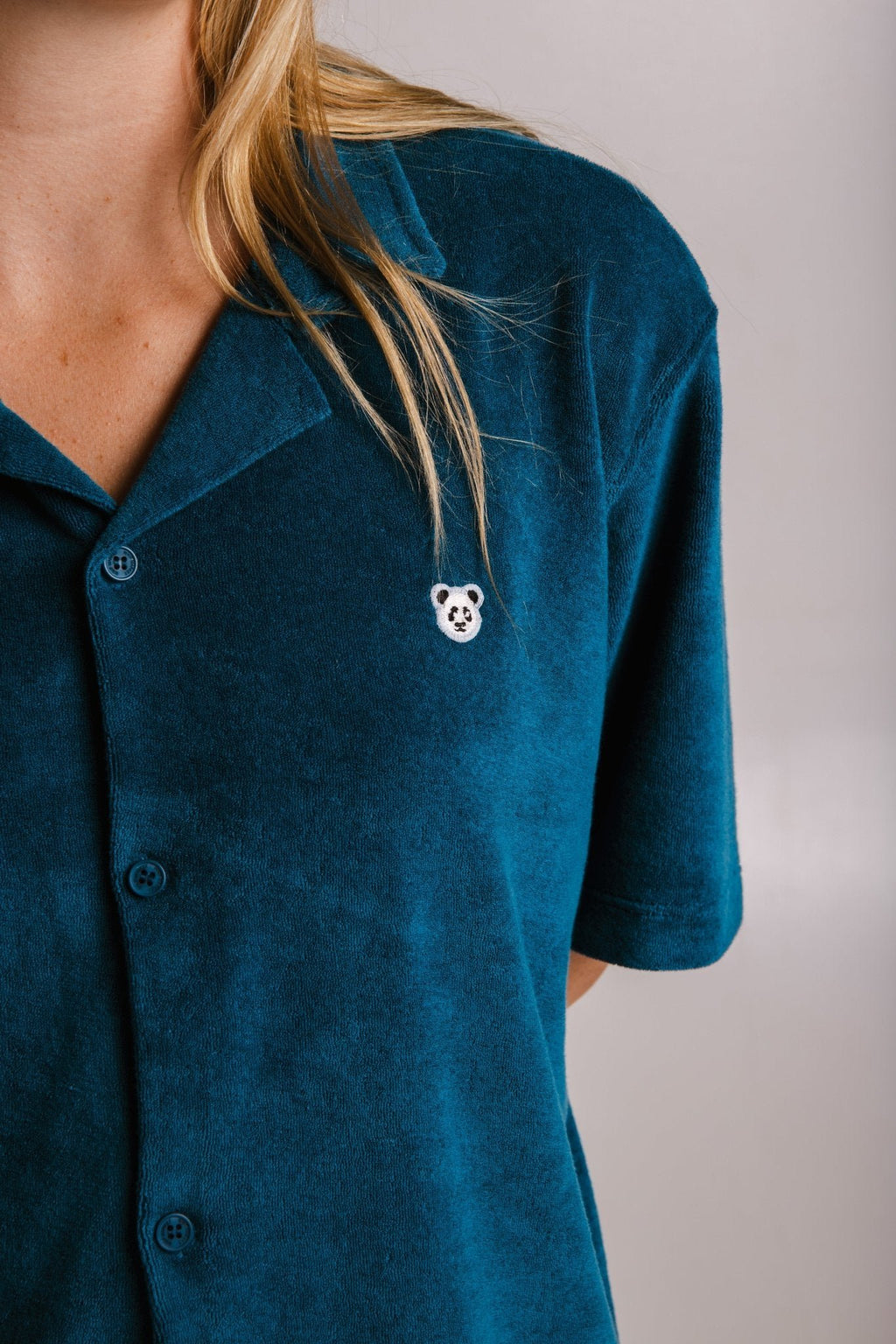 4. Close-up of women's unisex navy blue Panda Terry Shirt by Sossu, highlighting panda logo embroidery