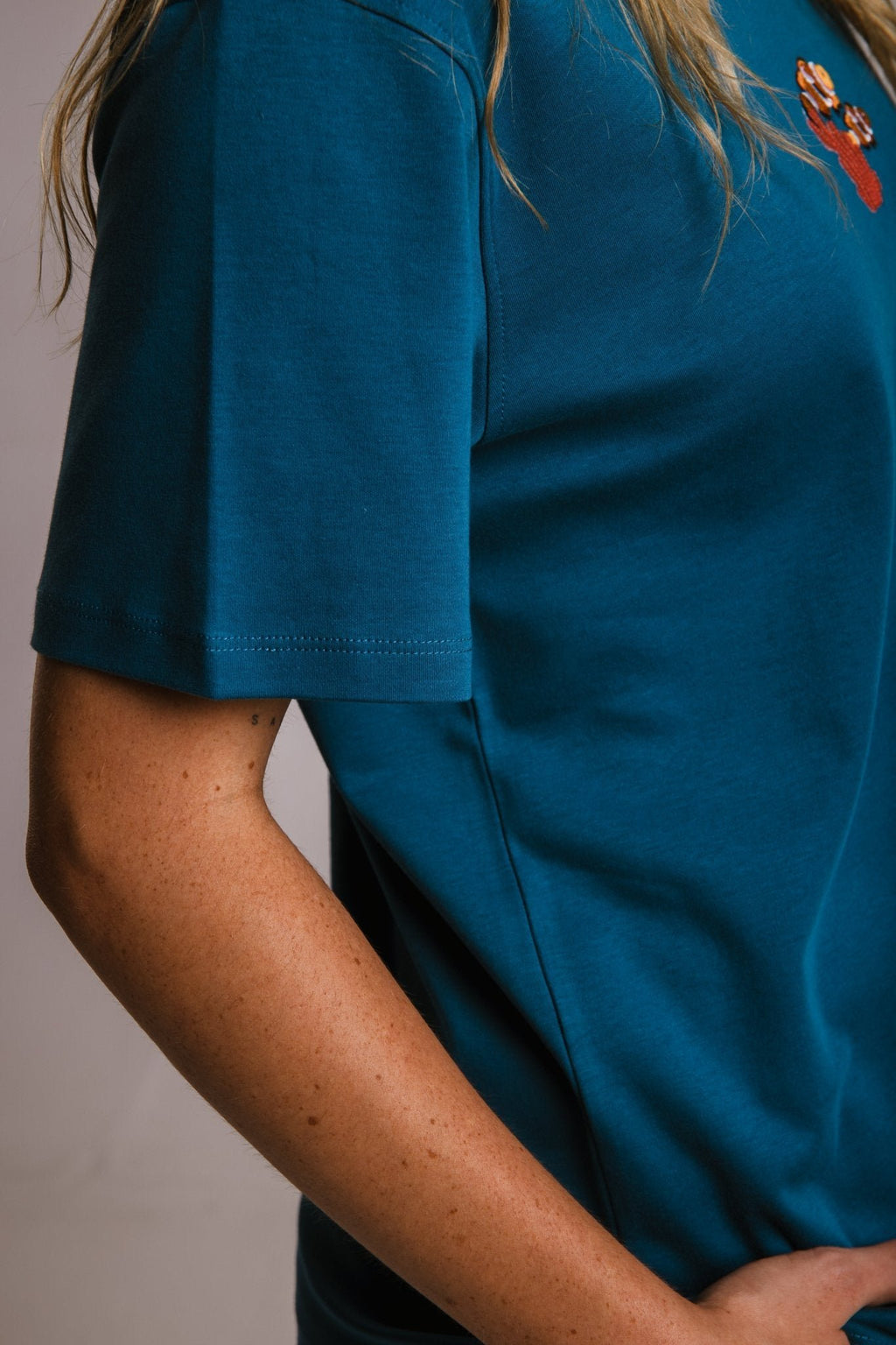 6. Close-up of women's unisex navy blue Panda Terry Shirt by Sossu, showing sleeve detail and fabric texture