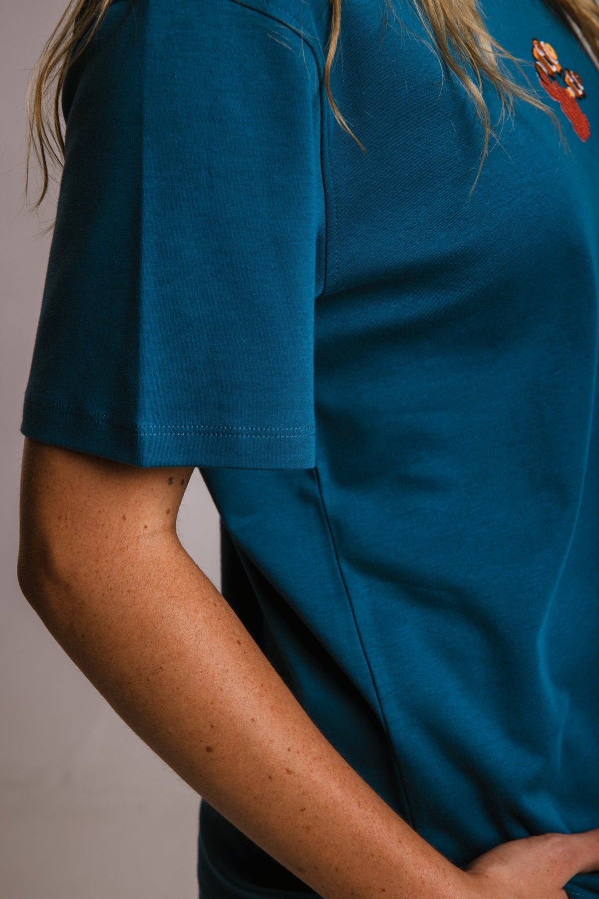 6. Close-up of women's unisex navy blue Panda Terry Shirt by Sossu, showing sleeve detail and fabric texture