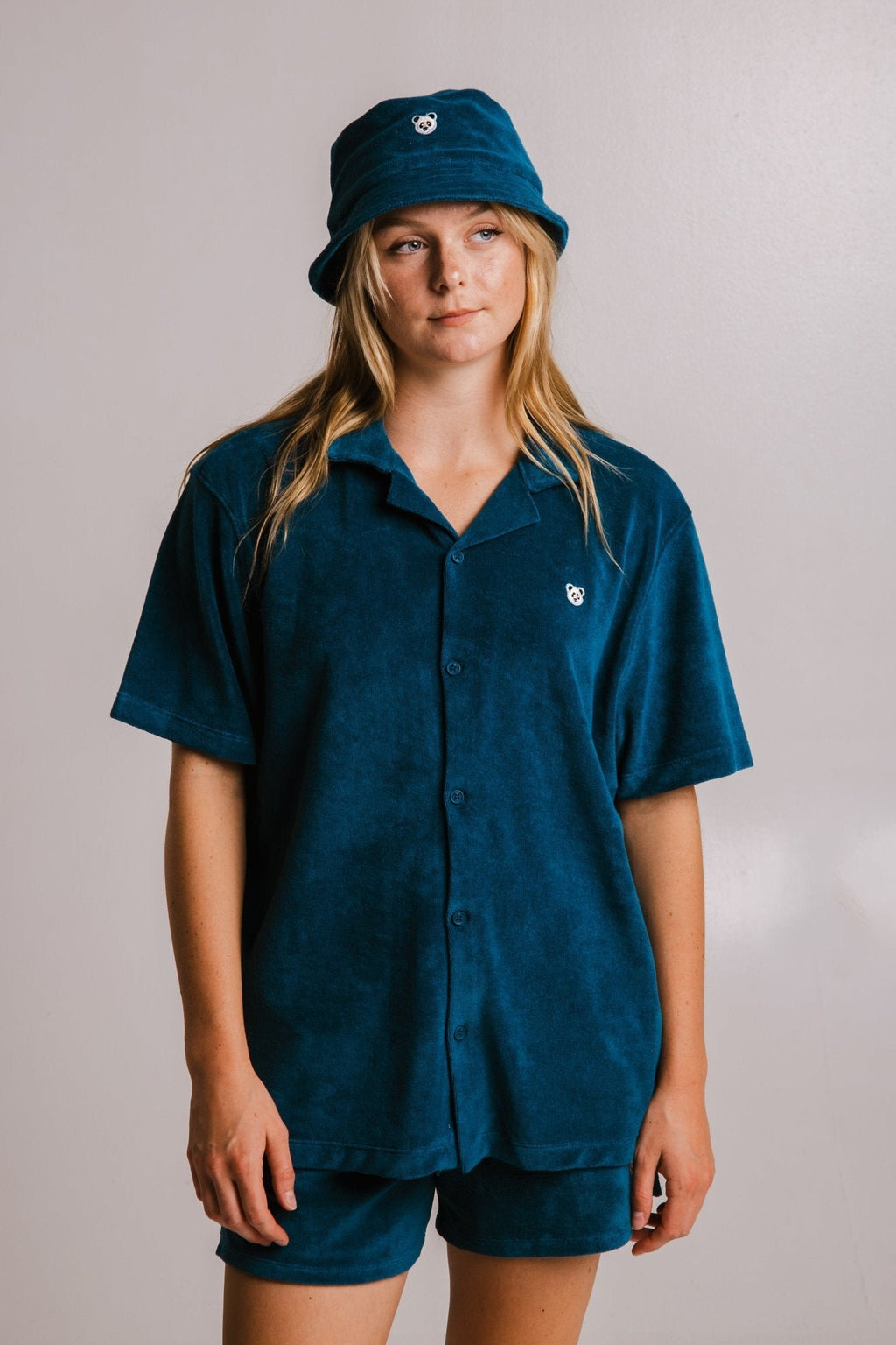 2. Women's unisex navy blue Panda Terry Shirt by Sossu, shown with matching bucket hat and shorts in studio