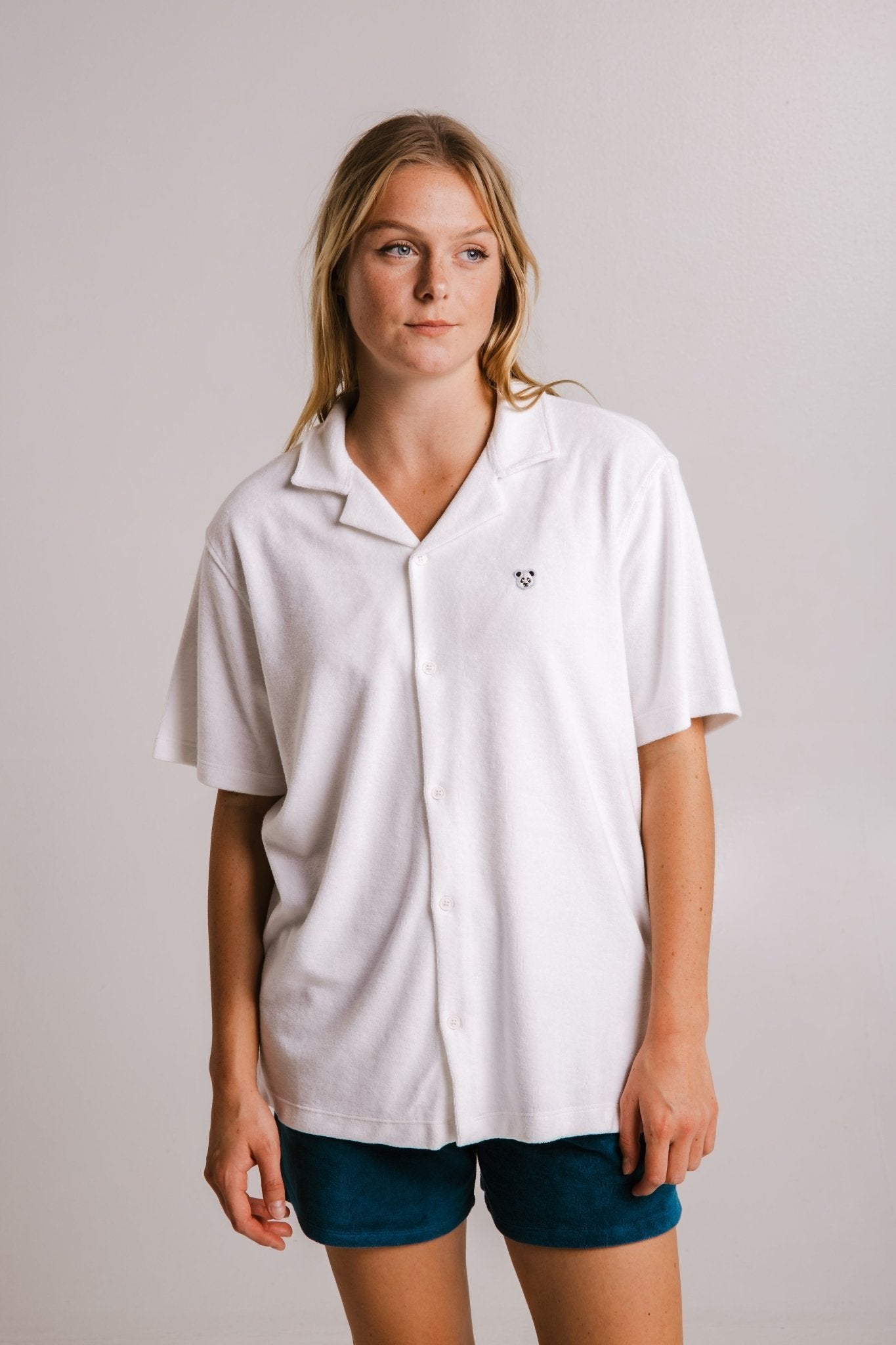 1. Women's white Panda Terry Shirt by Sossu, featuring a relaxed fit and embroidered panda detail, shown in a studio setting