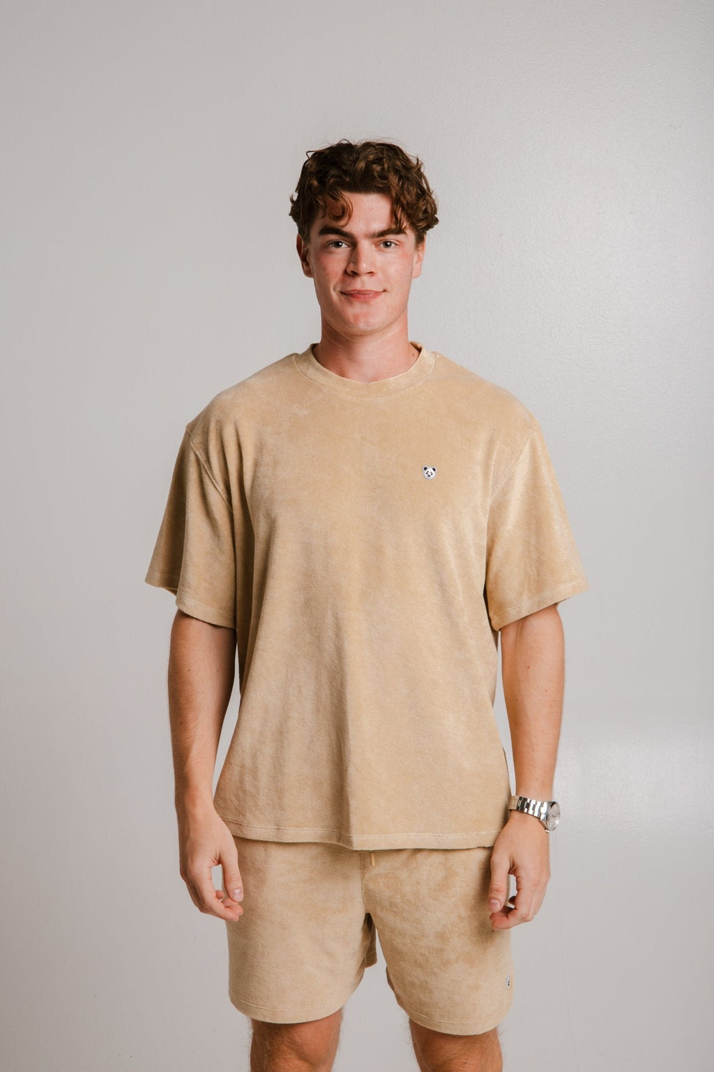 3. Front view of unisex light brown Panda Terry T-shirt by Sossu worn by male model, showing panda logo