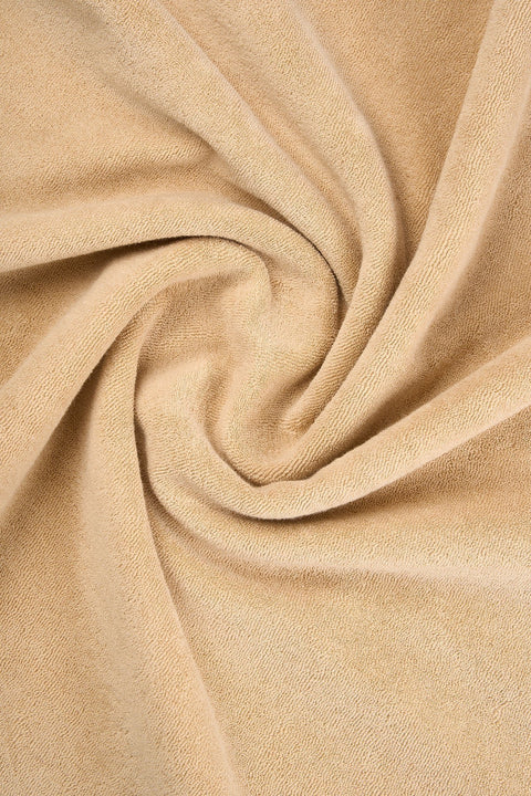 5. Close-up of light brown terry fabric texture of Sossu Panda T-shirt, showing material detail