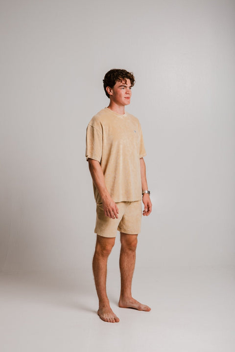 1. Unisex light brown Panda Terry T-shirt by Sossu worn by male model in studio, showcasing relaxed fit
