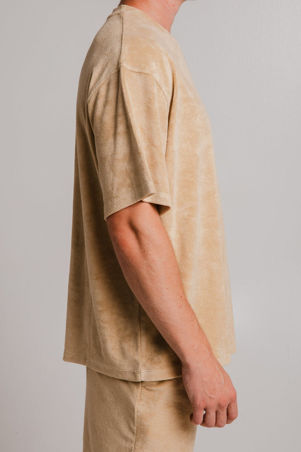 2. Side view of unisex light brown Panda Terry T-shirt by Sossu, highlighting oversize fit