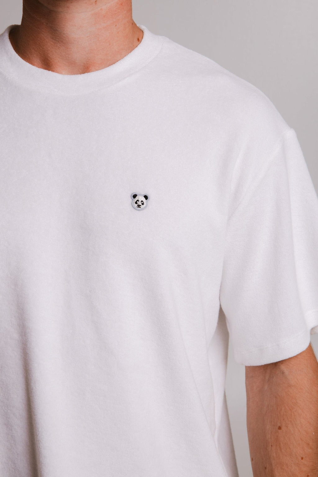 3. Close-up of panda logo on white Panda Terry T-shirt by Sossu