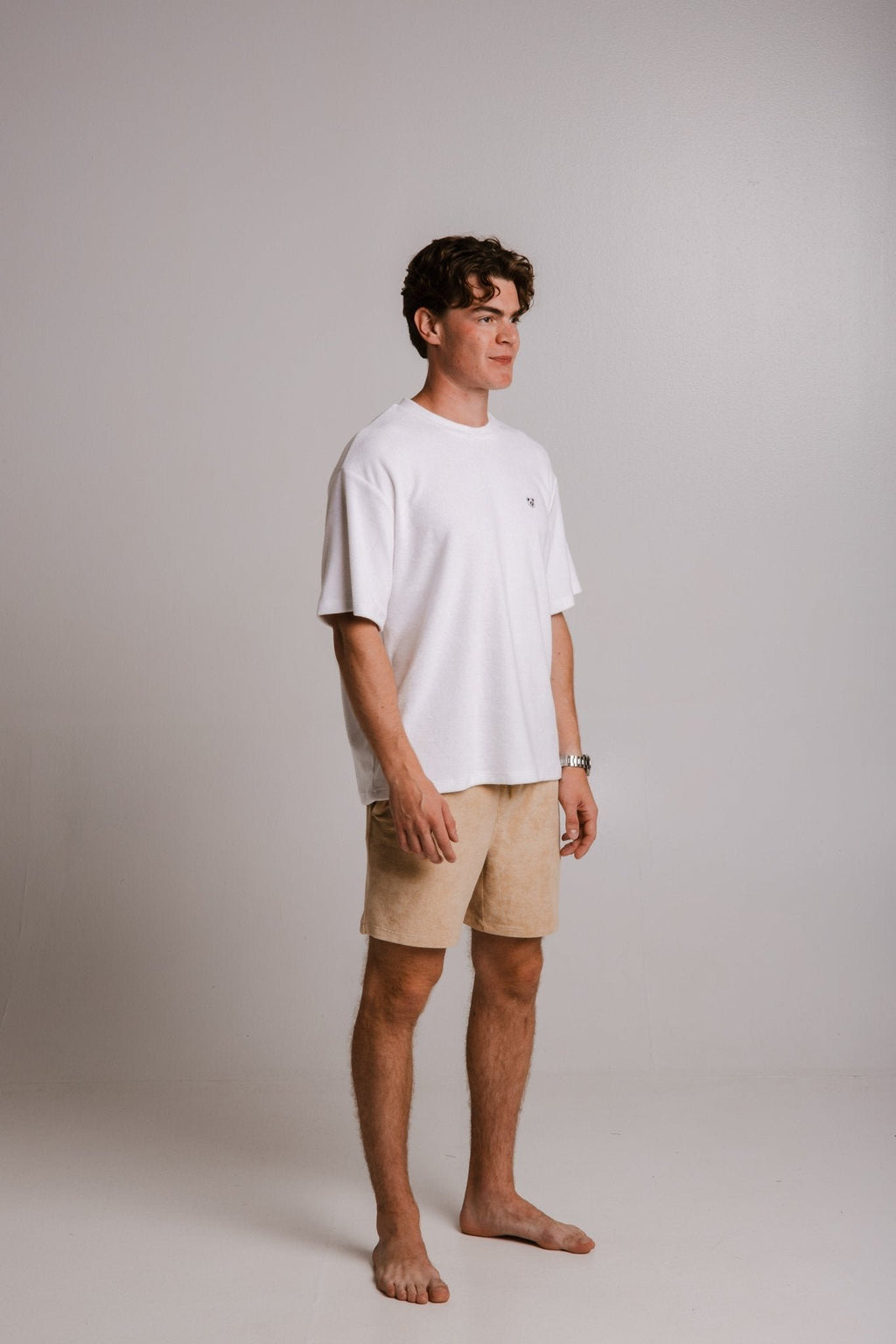 2. Unisex white Panda Terry T-shirt by Sossu worn by male model, side view