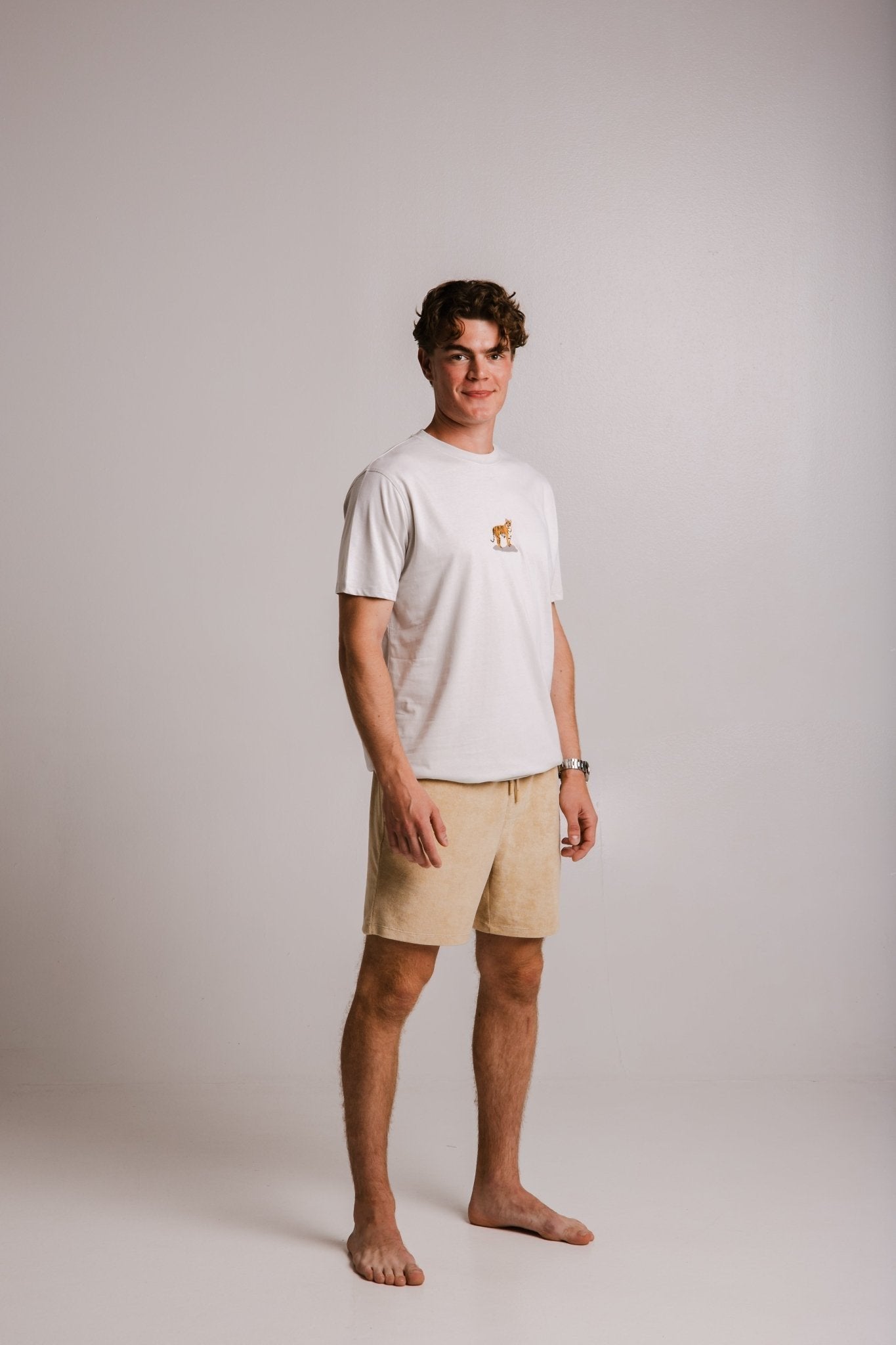 2. Men's white Sossu Squirrel T-shirt in studio, showcasing embroidered squirrel design