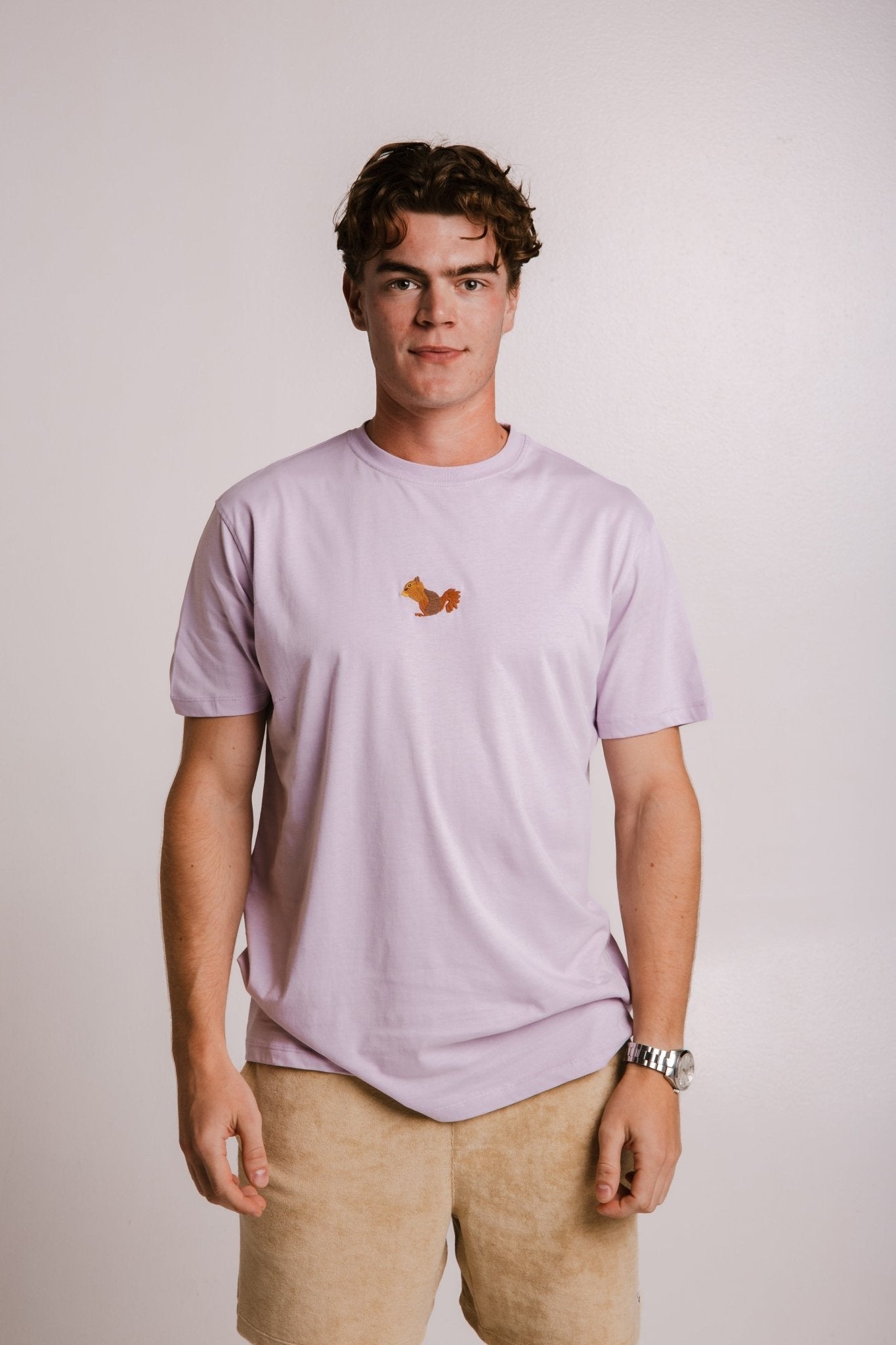 1. Men's lilac Sossu Squirrel T-shirt in studio setting, featuring embroidered squirrel design