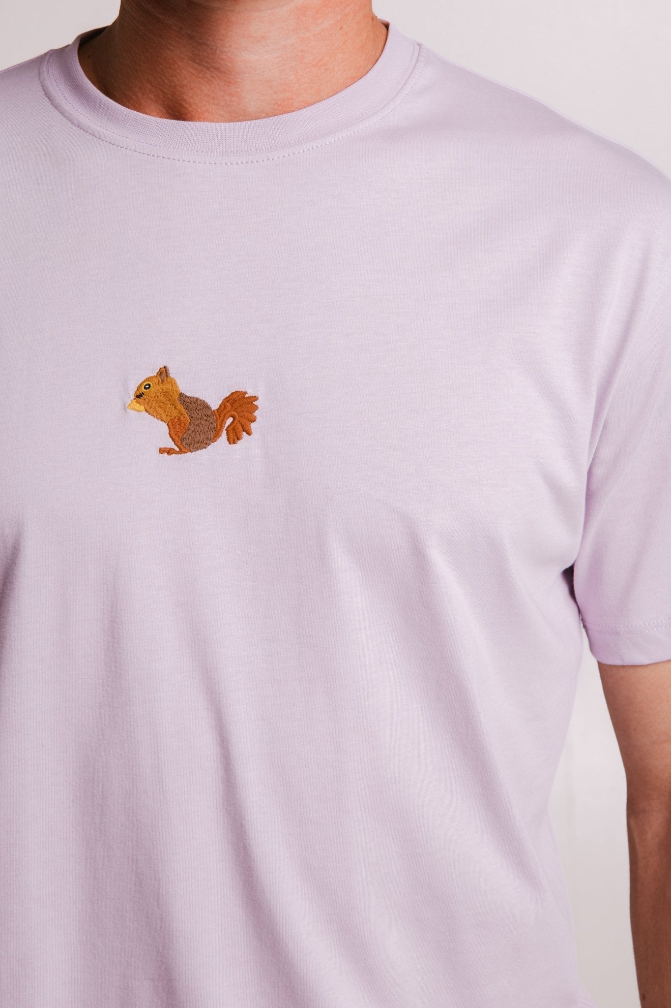 3. Close-up of lilac Sossu Squirrel T-shirt, highlighting embroidered squirrel detail