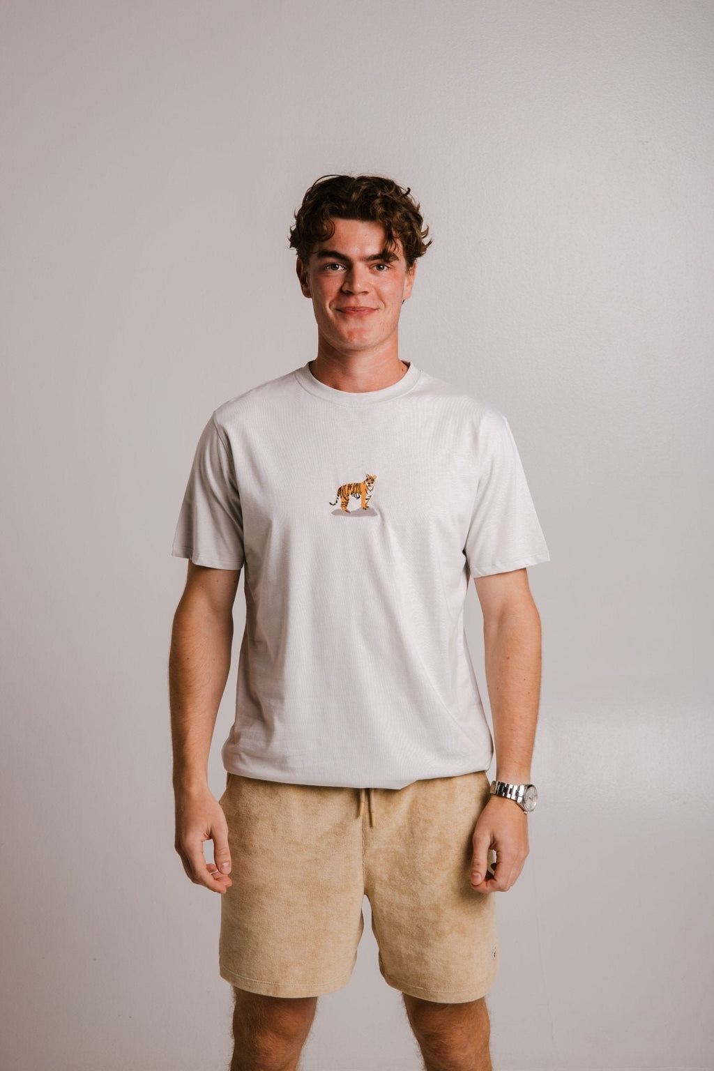 2. Men's grey Tiger T-shirt by Sossu, styled with beige shorts, full front view in studio