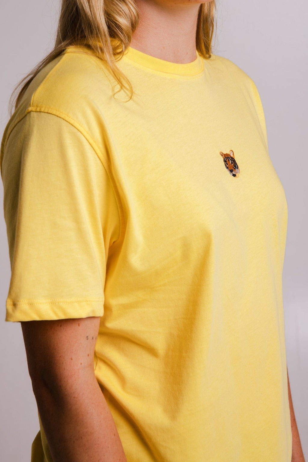 3. Close-up of yellow Tiger T-shirt by Sossu, highlighting embroidered tiger logo