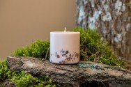 5. Top view of TL Candles hand-made soy wax candle with amber pieces and branded packaging