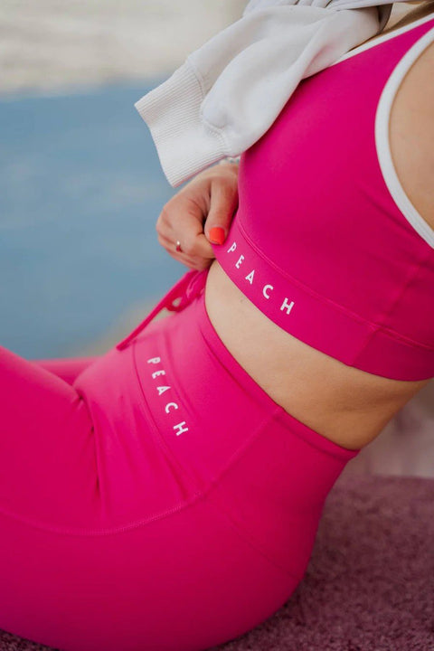 4. Close-up of Peachlabel Raspberry Dream sports bra and leggings, showing brand logo
