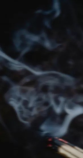 3. Incense smoke rising in a dark setting, representing the mystical element in the Temple of Sensus perfume