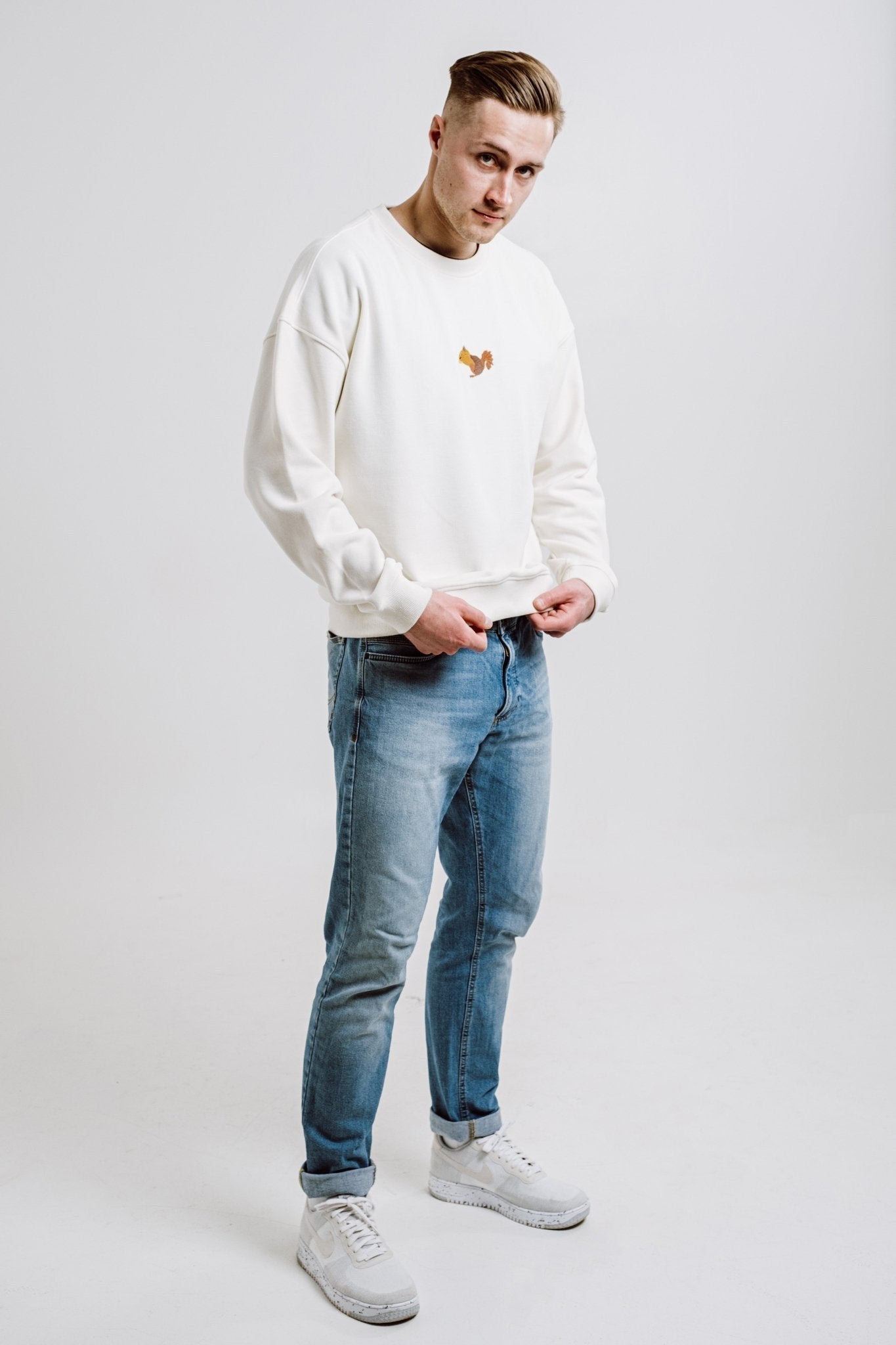 7. Flat lay of unisex cream Sossu Squirrel Sweatshirt with embroidered squirrel design