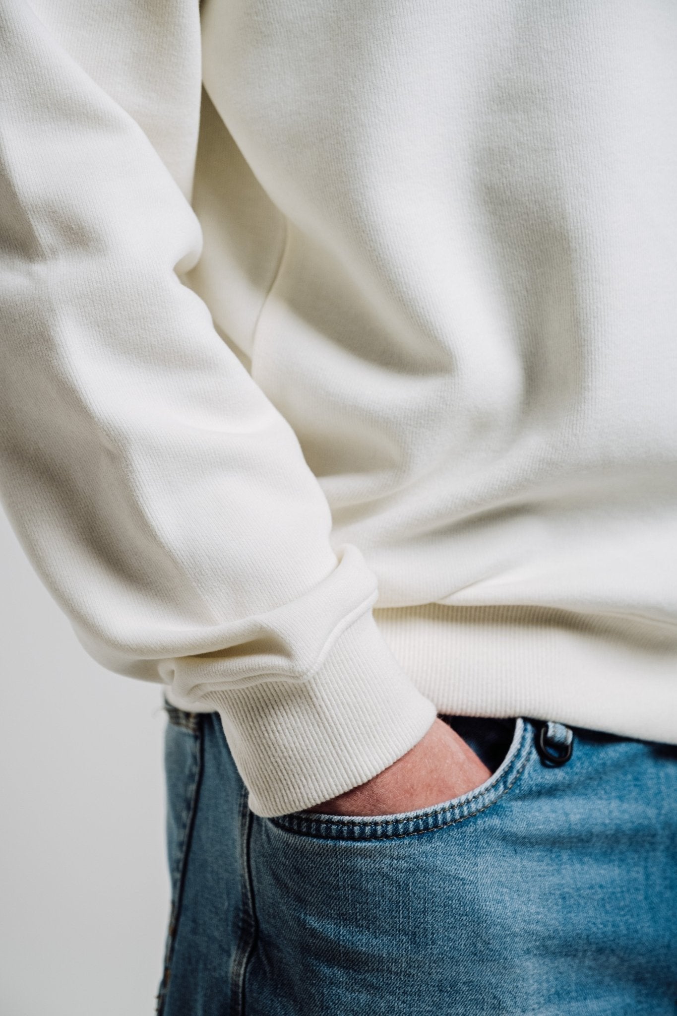 1. Unisex cream Sossu Squirrel Sweatshirt worn by male model in studio, showcasing relaxed fit
