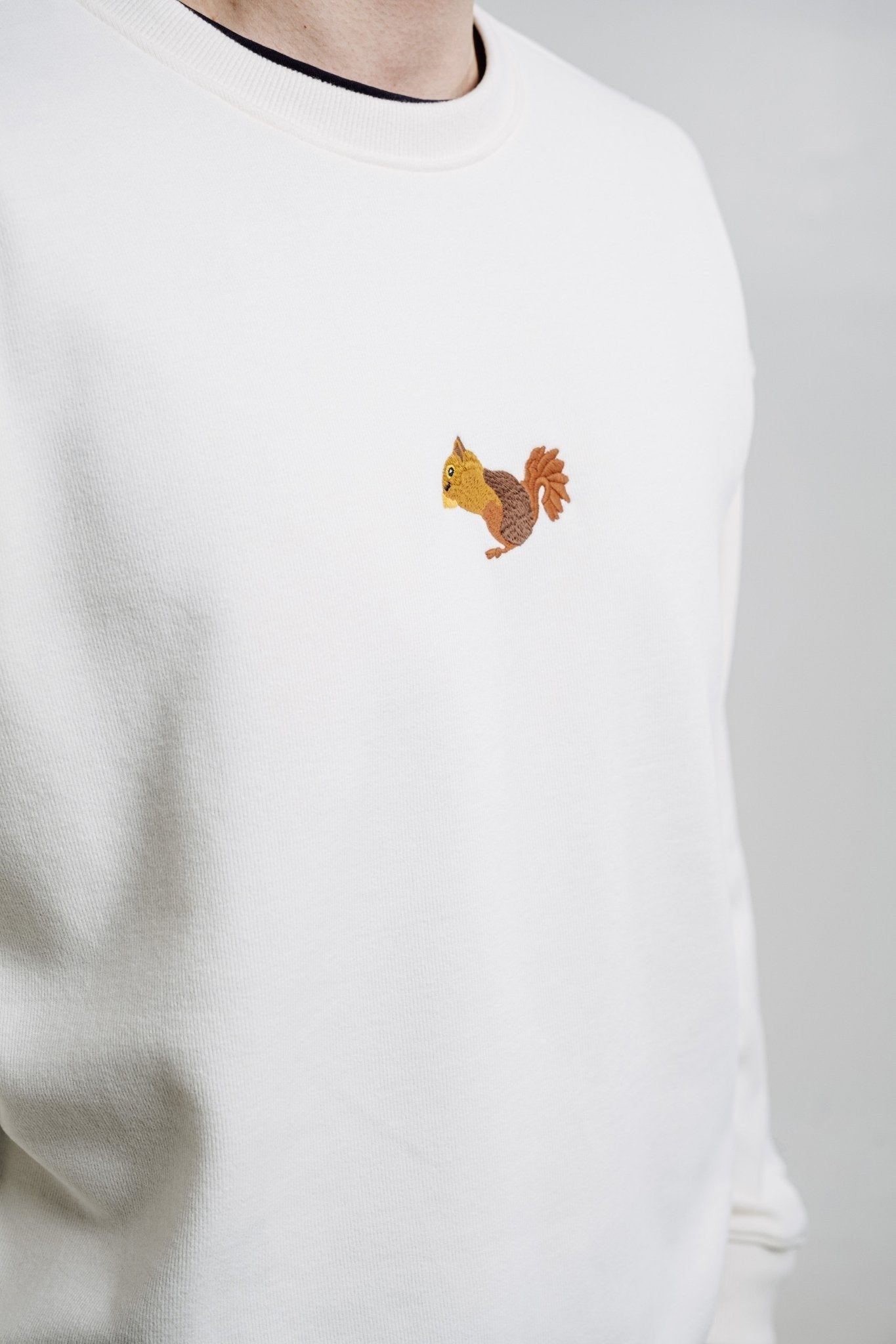 3. Studio shot of unisex cream Sossu Squirrel Sweatshirt with embroidered squirrel design