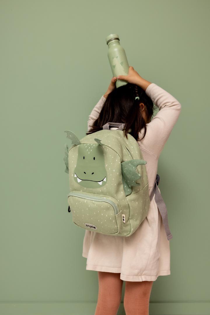 8. Child wearing green dragon-themed backpack holding matching stainless steel bottle overhead