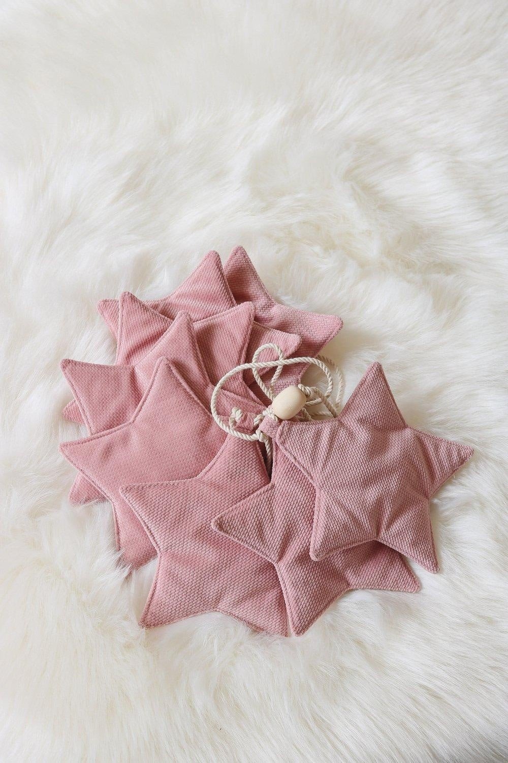 4. Flat lay of soft pink velvet star garland on fluffy white background